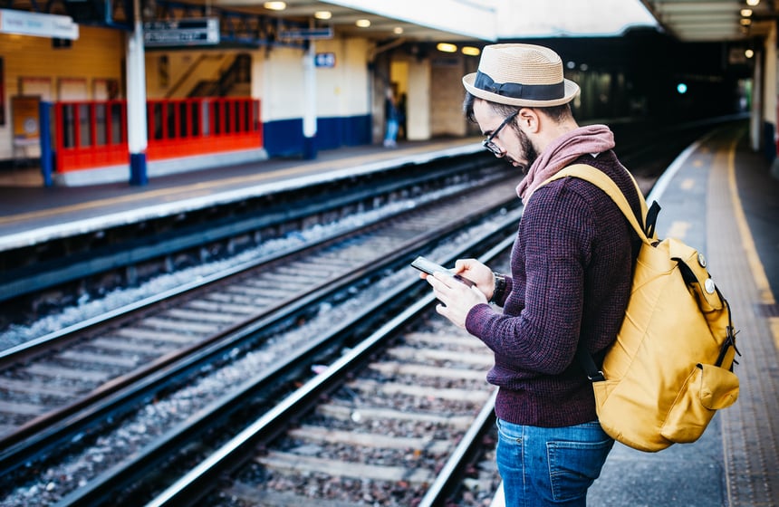 man-in-brown-hoodie-standing-in-front-of-train-railway-211052